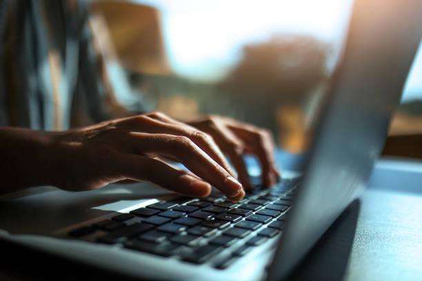 Clinician typing patient chart notes on a computer
